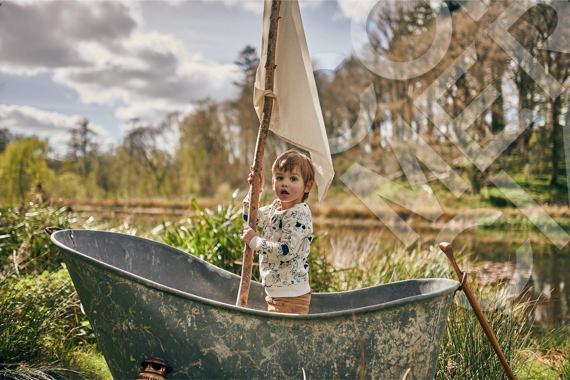 Small boy in tin bath boat